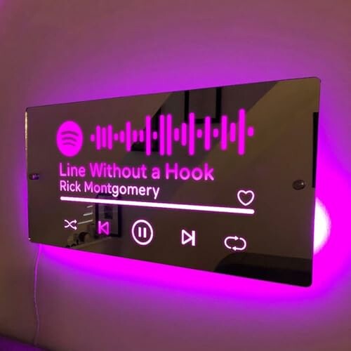 Illuminated Spotify song display with music controls.
